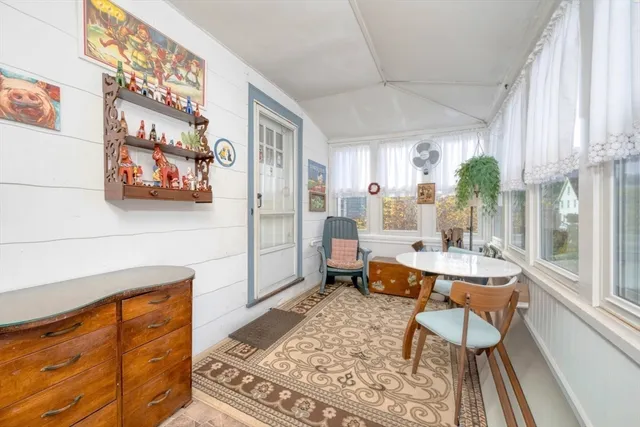 a living room with furniture and a painting on the wall