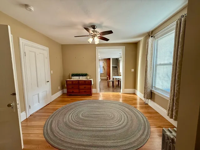 a room with wooden floor and furniture