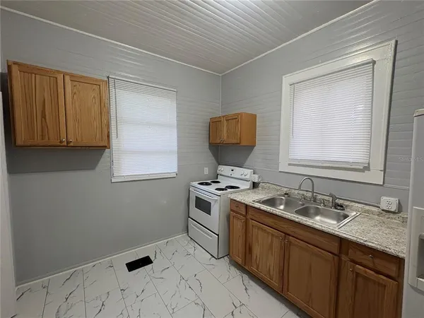 a kitchen with a sink stove and cabinets