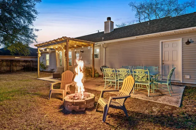 a backyard of a house with table and chairs
