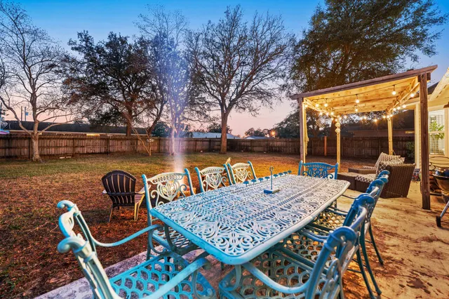 a view of a backyard with sitting area and lake view