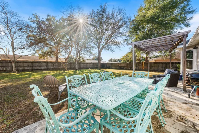 a view of backyard with swimming pool and patio
