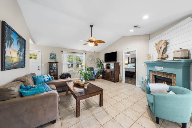 a living room with furniture a fireplace and a flat screen tv