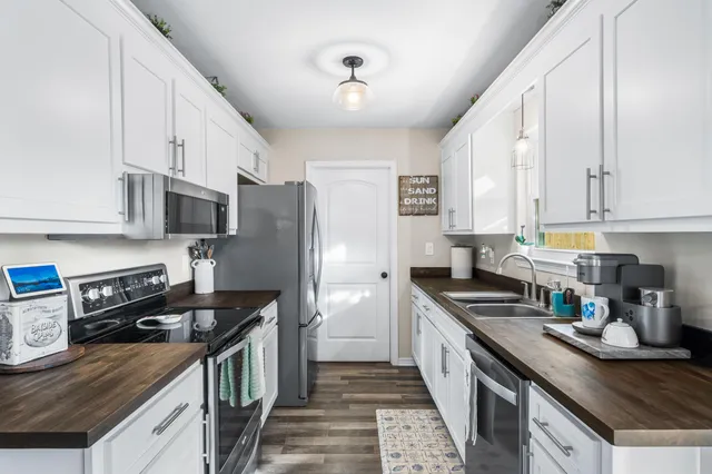 a kitchen with stainless steel appliances a stove refrigerator sink and cabinets