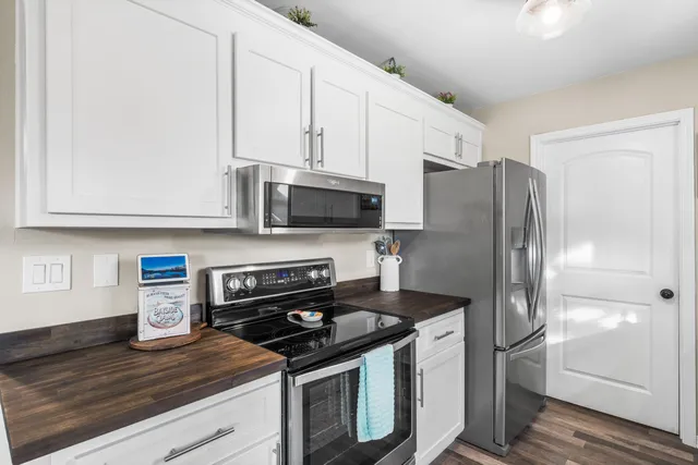 a kitchen with stainless steel appliances granite countertop a refrigerator stove and microwave