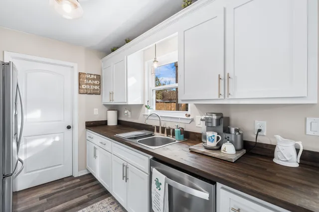 a kitchen with sink and cabinets