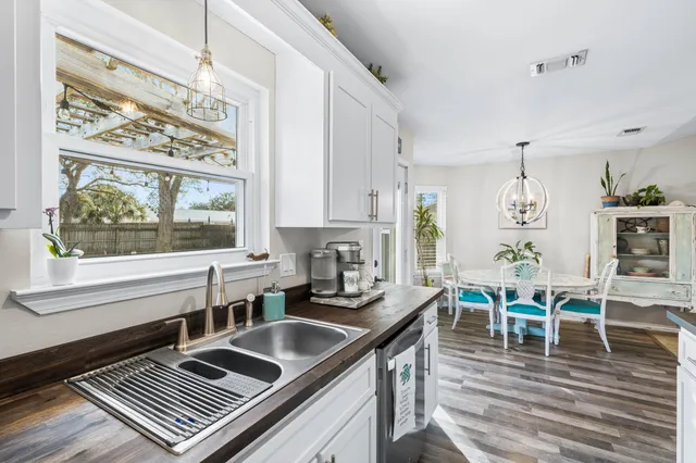 a kitchen with a table chairs stove and cabinets