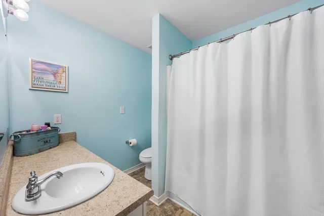 a bathroom with a sink and a mirror with toilet