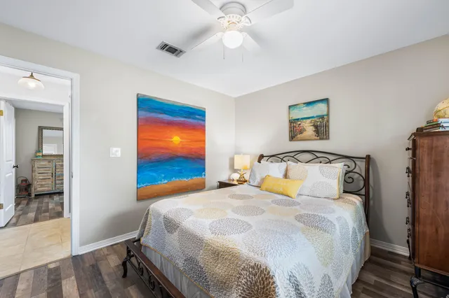 a bedroom with a large bed and a chandelier
