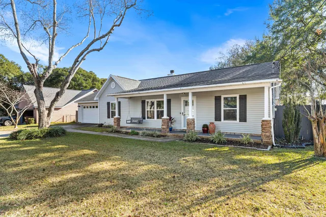 a view of a house with a swimming pool and a yard