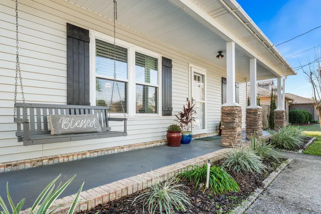 a view of a house with backyard and sitting area