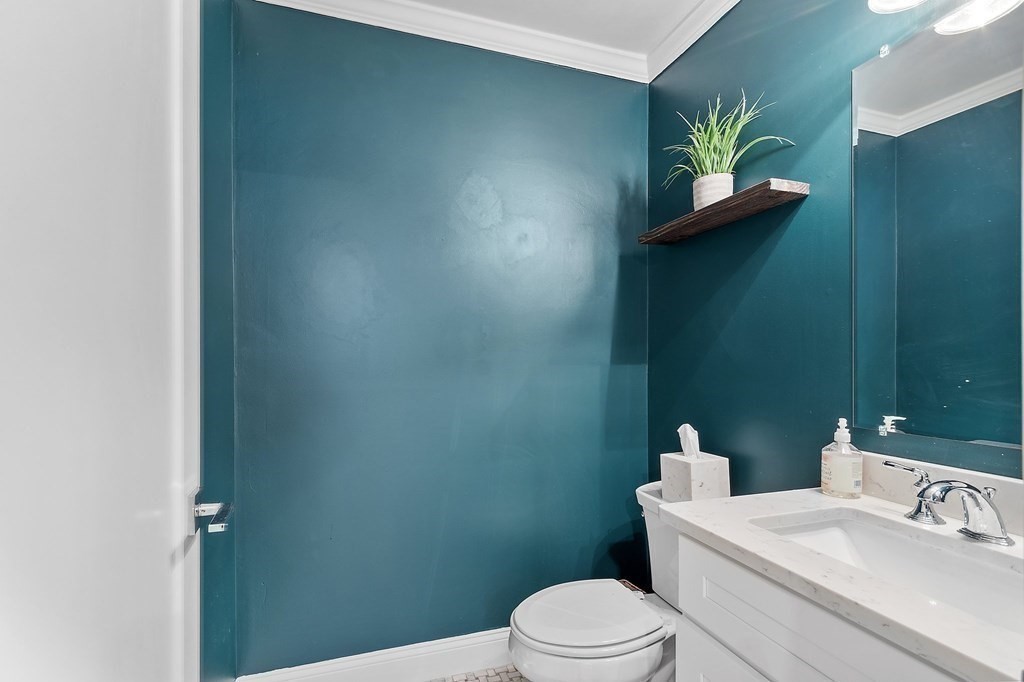 30 Iffley Road, Unit 1 Boston, MA 02130 - Photo 13 of 29 a white toilet sitting next to a bathroom sink