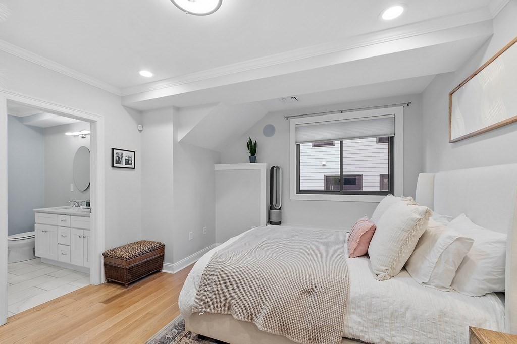 30 Iffley Road, Unit 1 Boston, MA 02130 - Photo 15 of 29 a bedroom with a bed and a large mirror