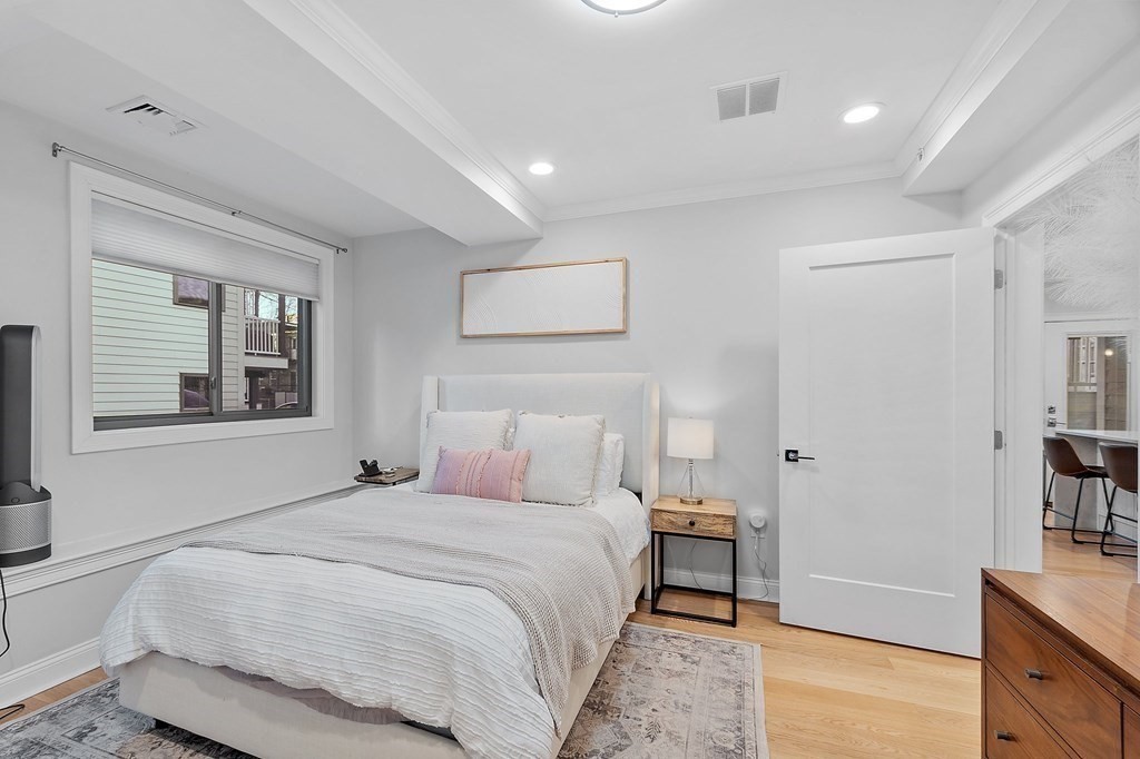 30 Iffley Road, Unit 1 Boston, MA 02130 - Photo 16 of 29 a bedroom with a bed and a night stand