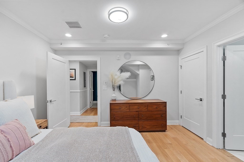 30 Iffley Road, Unit 1 Boston, MA 02130 - Photo 17 of 29 a bedroom with a bed and a mirror