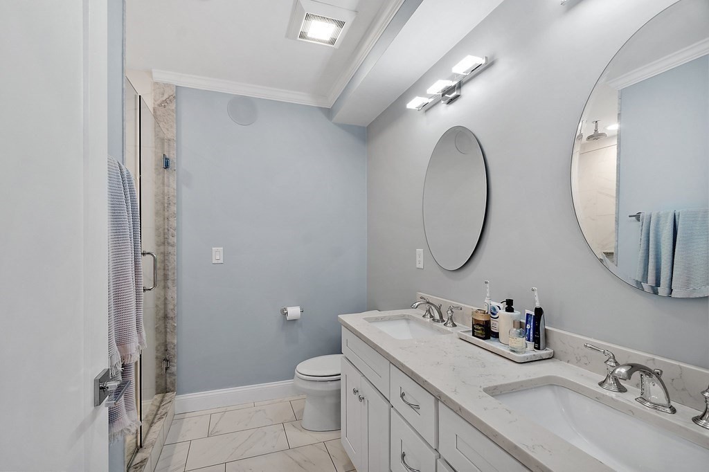 30 Iffley Road, Unit 1 Boston, MA 02130 - Photo 18 of 29 a bathroom with a toilet sink and mirror