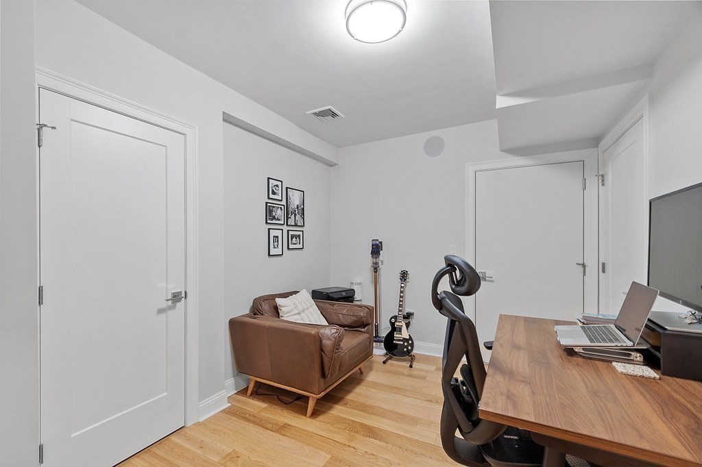 30 Iffley Road, Unit 1 Boston, MA 02130 - Photo 22 of 29 a room with furniture and a wooden floor