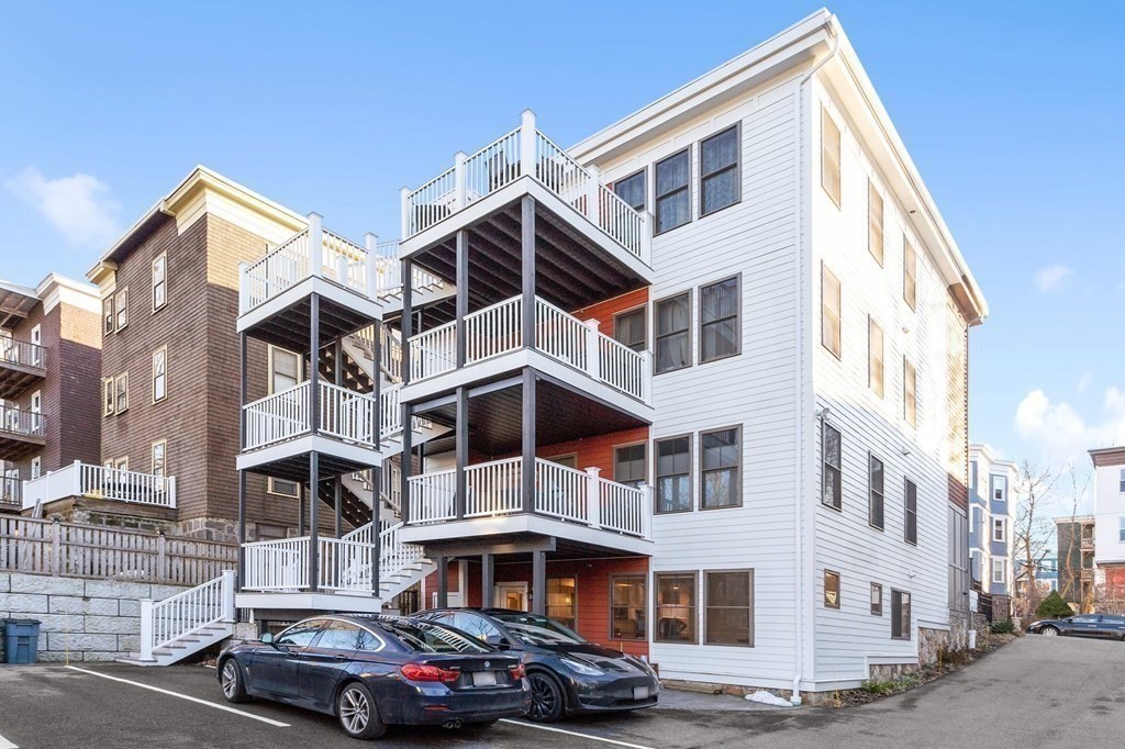 30 Iffley Road, Unit 1 Boston, MA 02130 - Photo 26 of 29 a front view of a residential apartment building with a yard