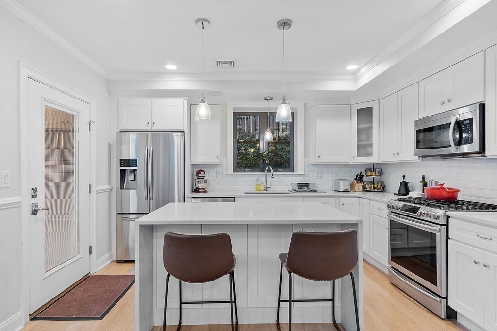 30 Iffley Road, Unit 1 Boston, MA 02130 - Photo 4 of 29 a kitchen with stainless steel appliances a stove refrigerator sink and microwave