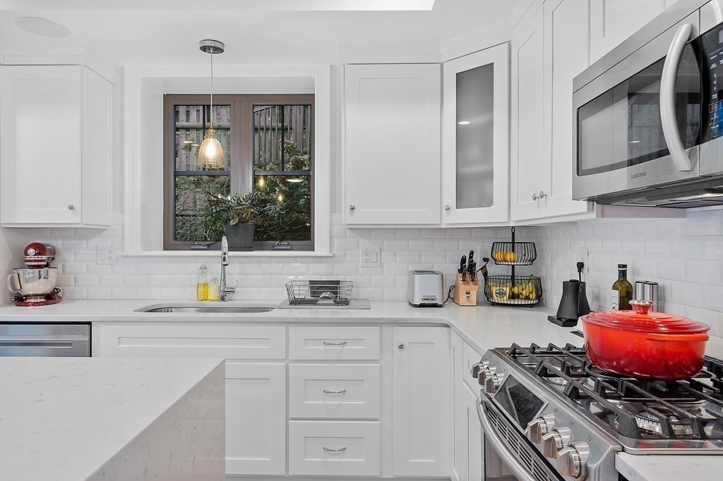 30 Iffley Road, Unit 1 Boston, MA 02130 - Photo 5 of 29 a kitchen with stainless steel appliances granite countertop a sink stove and cabinets