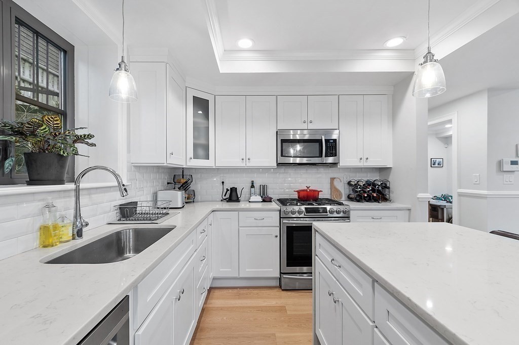 30 Iffley Road, Unit 1 Boston, MA 02130 - Photo 7 of 29 a kitchen with a sink white cabinets and white appliances
