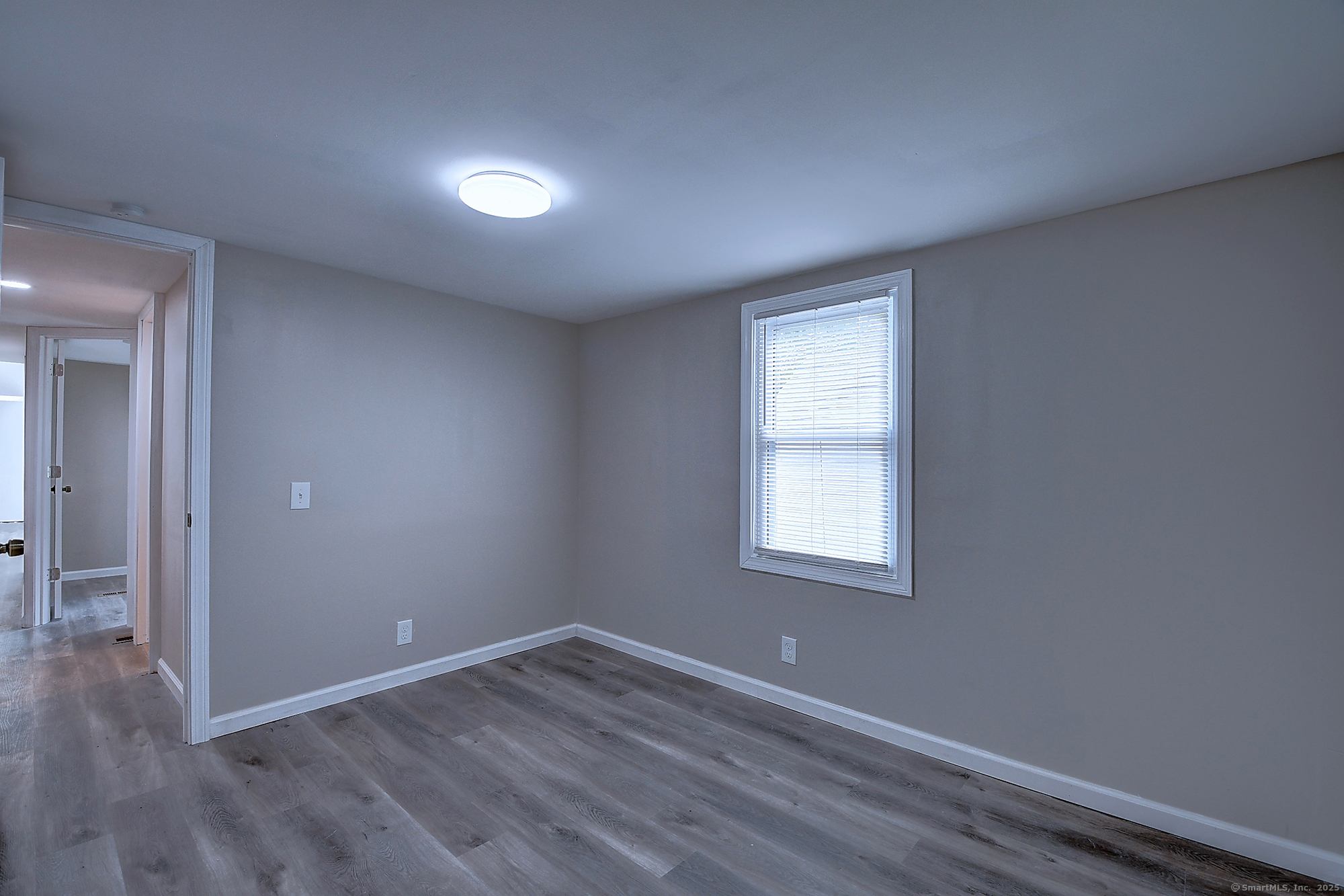 66 Nancy Lane Naugatuck, CT 06770 - Photo 12 of 25 an empty room with wooden floor and windows