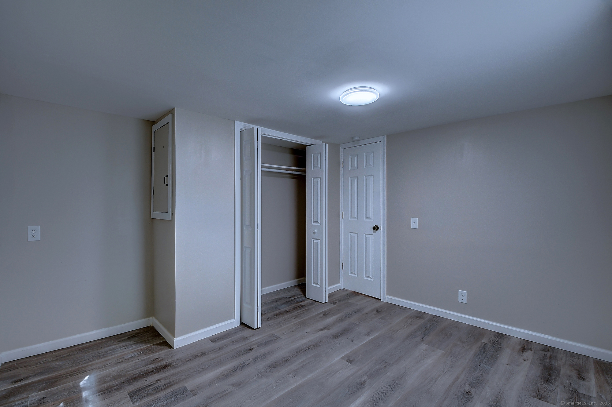 66 Nancy Lane Naugatuck, CT 06770 - Photo 13 of 25 an empty room with wooden floor and closet