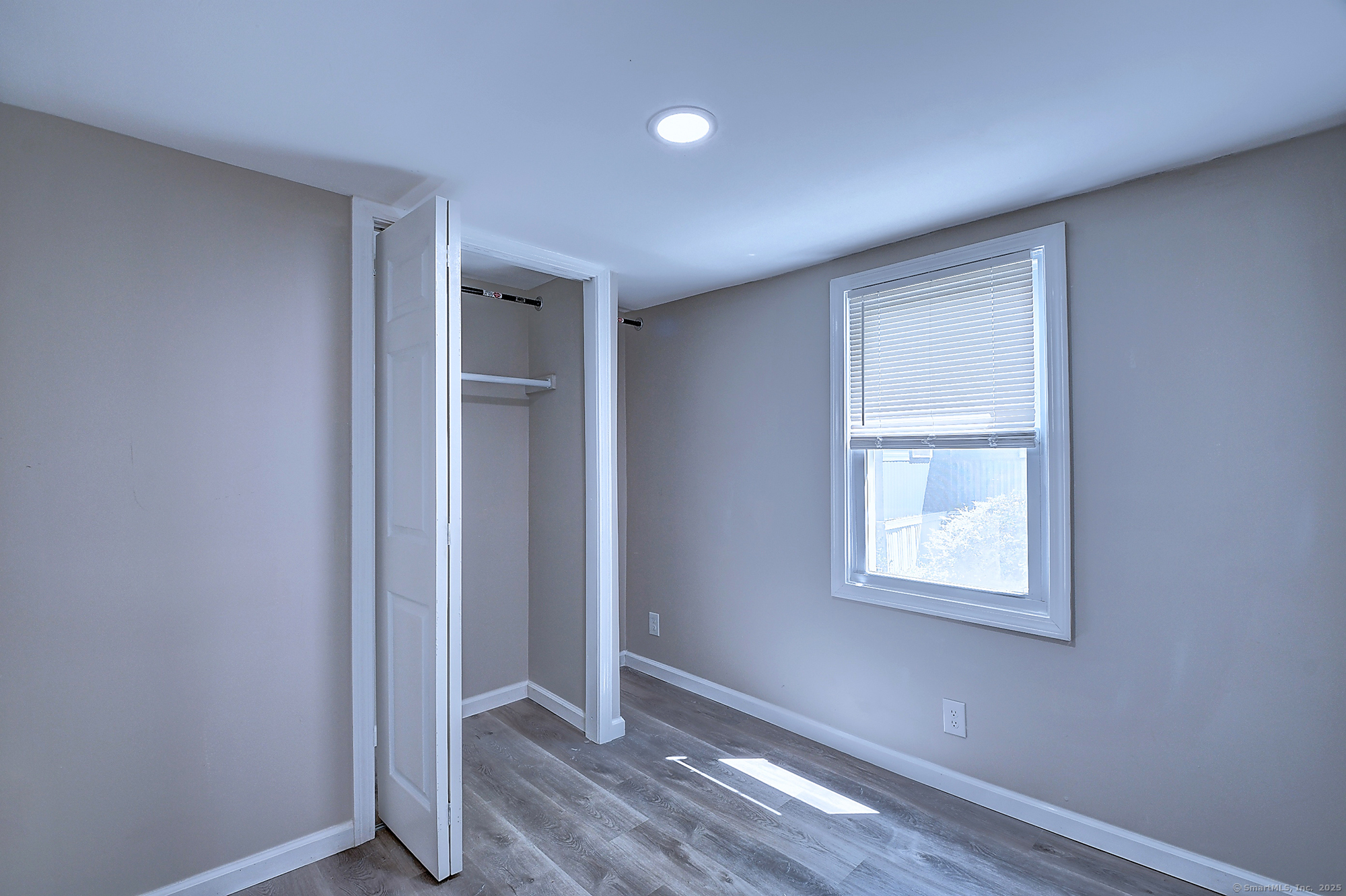 66 Nancy Lane Naugatuck, CT 06770 - Photo 22 of 25 an empty room with wooden floor closet and windows