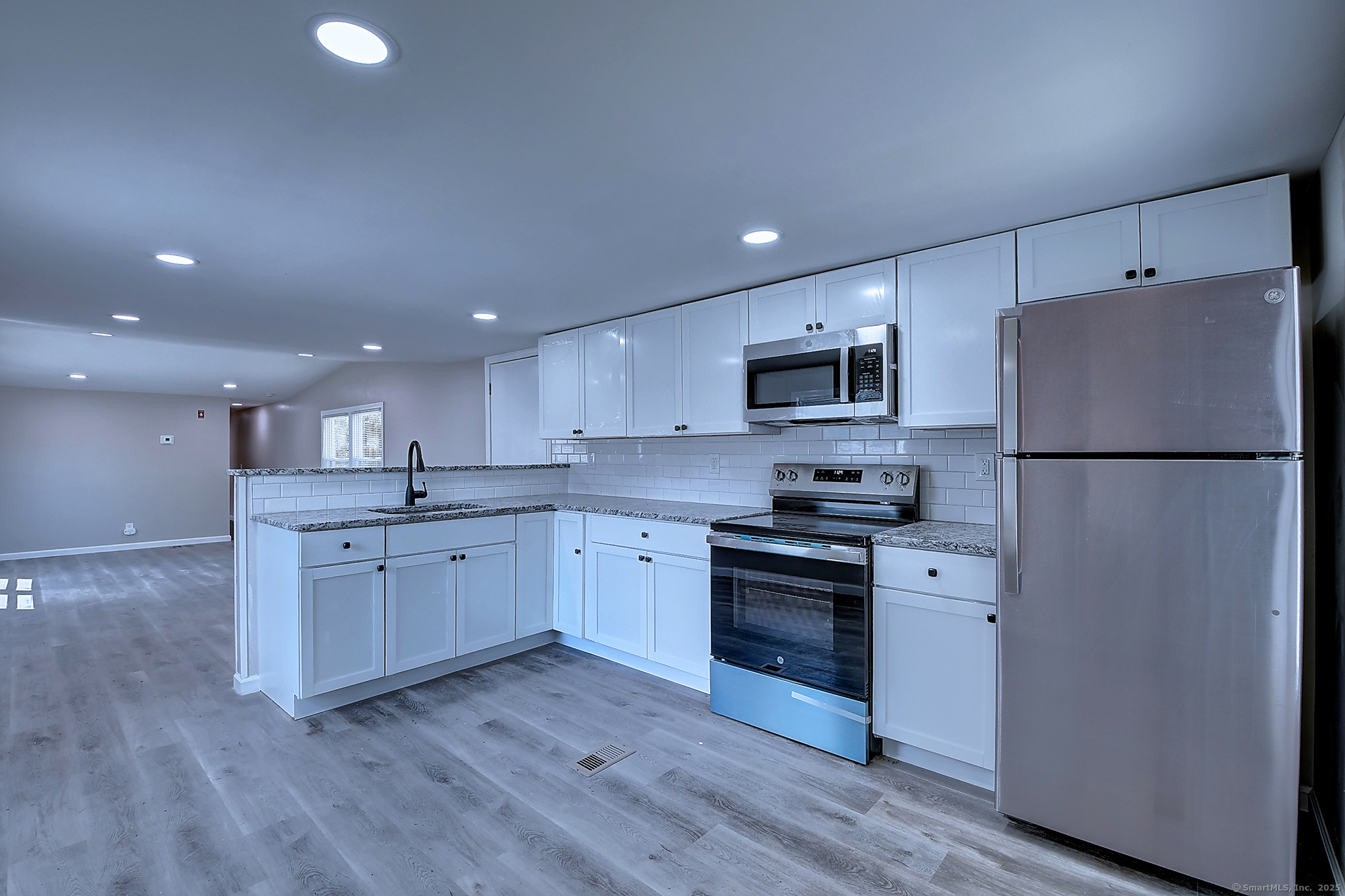 66 Nancy Lane Naugatuck, CT 06770 - Photo 4 of 25 a kitchen with a refrigerator stove and sink