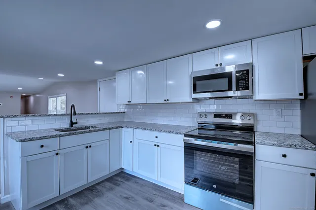 a kitchen with a sink stove and microwave
