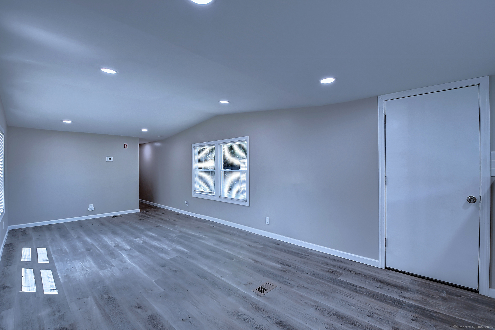 66 Nancy Lane Naugatuck, CT 06770 - Photo 8 of 25 a view of an empty room with wooden floor and a window