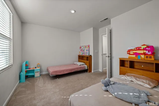 a bedroom with furniture and a dresser