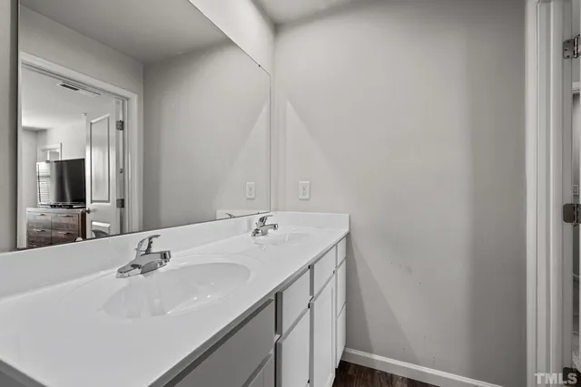 a bathroom with a sink toilet vanity and tub