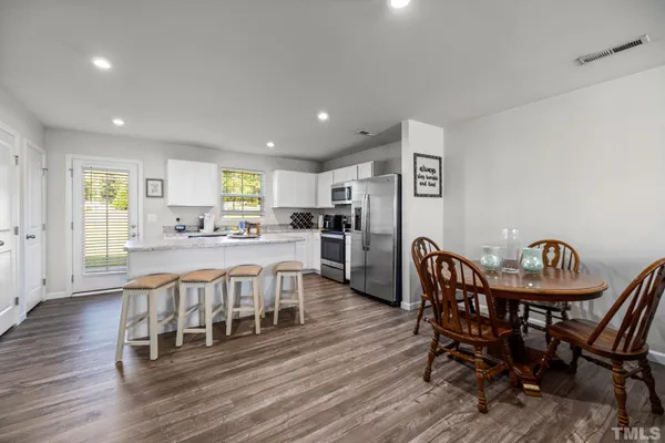 a view of a dining room with furniture and wooden floor