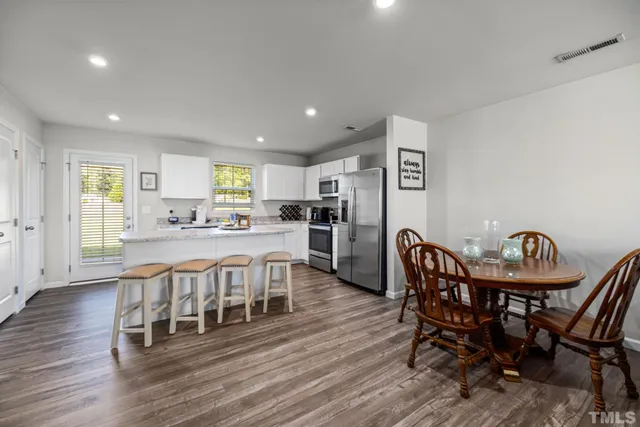 a view of a dining room with furniture and wooden floor