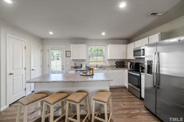 a large kitchen with lots of counter space and stainless steel appliances