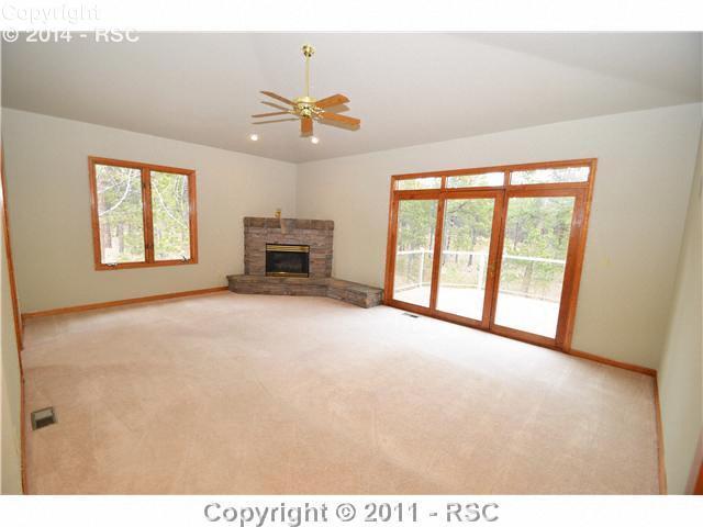 7270 Shoup Road Colorado Springs, CO 80908 - Photo 6 of 16 Master bedroom suite has its own fireplace and Trex deck and sits on its own private wing. The five piece bath has double vanity, large soaking tub with glass block window, steam shower, and his and hers walk-in closets.