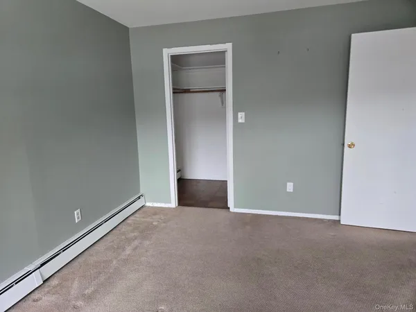 an empty room with closet area
