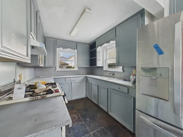 a kitchen with stainless steel appliances granite countertop a stove a refrigerator and a sink