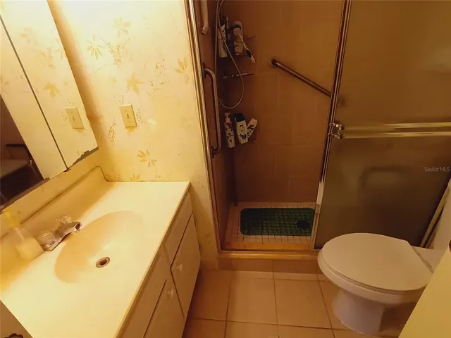 a bedroom with a bed and a television