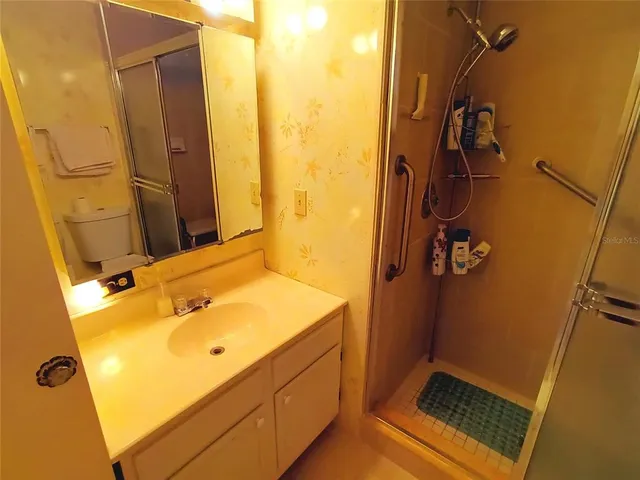 a bed room with a bed and a chair