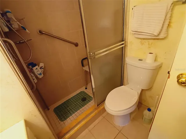 a bedroom with a bed and a mirror