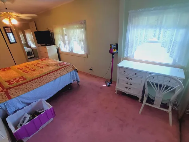 a living room with furniture a rug and a flat screen tv