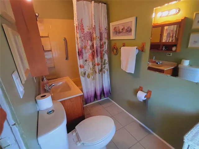 a kitchen with a sink a refrigerator and cabinets