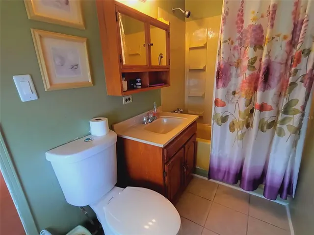 a living room with furniture a rug and a table