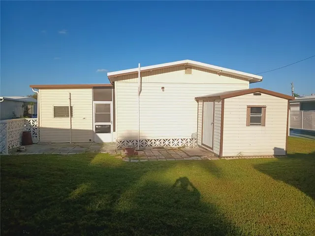 a living room with furniture and floor to ceiling windows