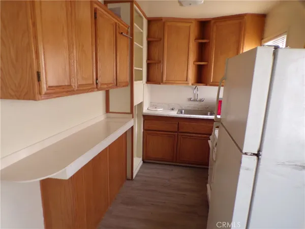 a kitchen with a sink a refrigerator a washer and dryer