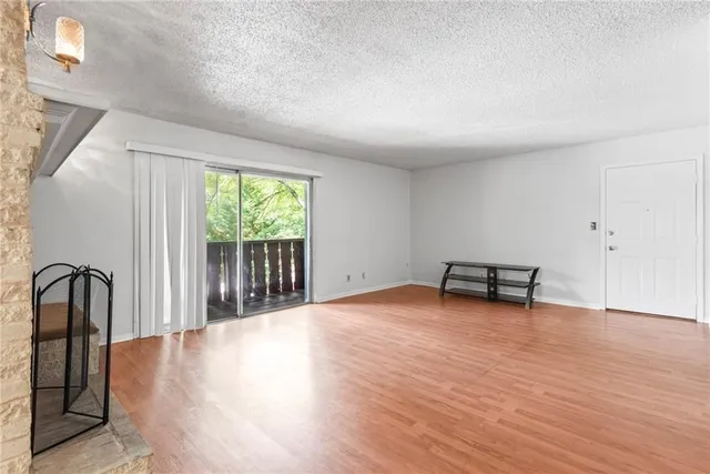 a view of a room with wooden floor and a window