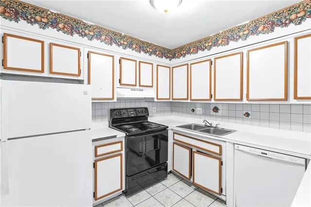 a kitchen with stainless steel appliances a stove sink and cabinets