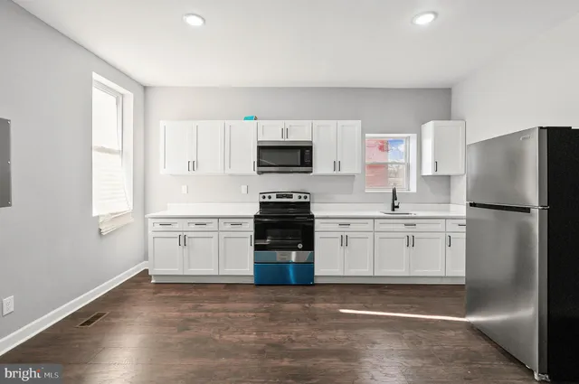a kitchen with a refrigerator stove and sink